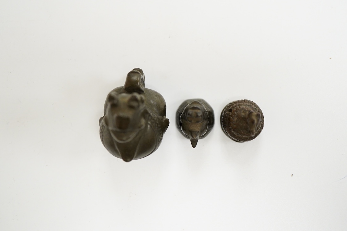 Two 19th century Burmese bronze weights, and a similar figure of a mythical beast, largest 4cm high